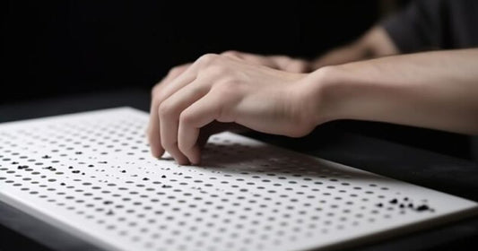 Hands using a modern Braille typewriter, showcasing the evolution of tactile writing technology for visually impaired individuals.