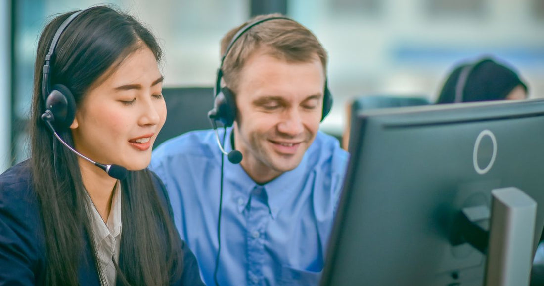 Blind colleagues working together with headphones