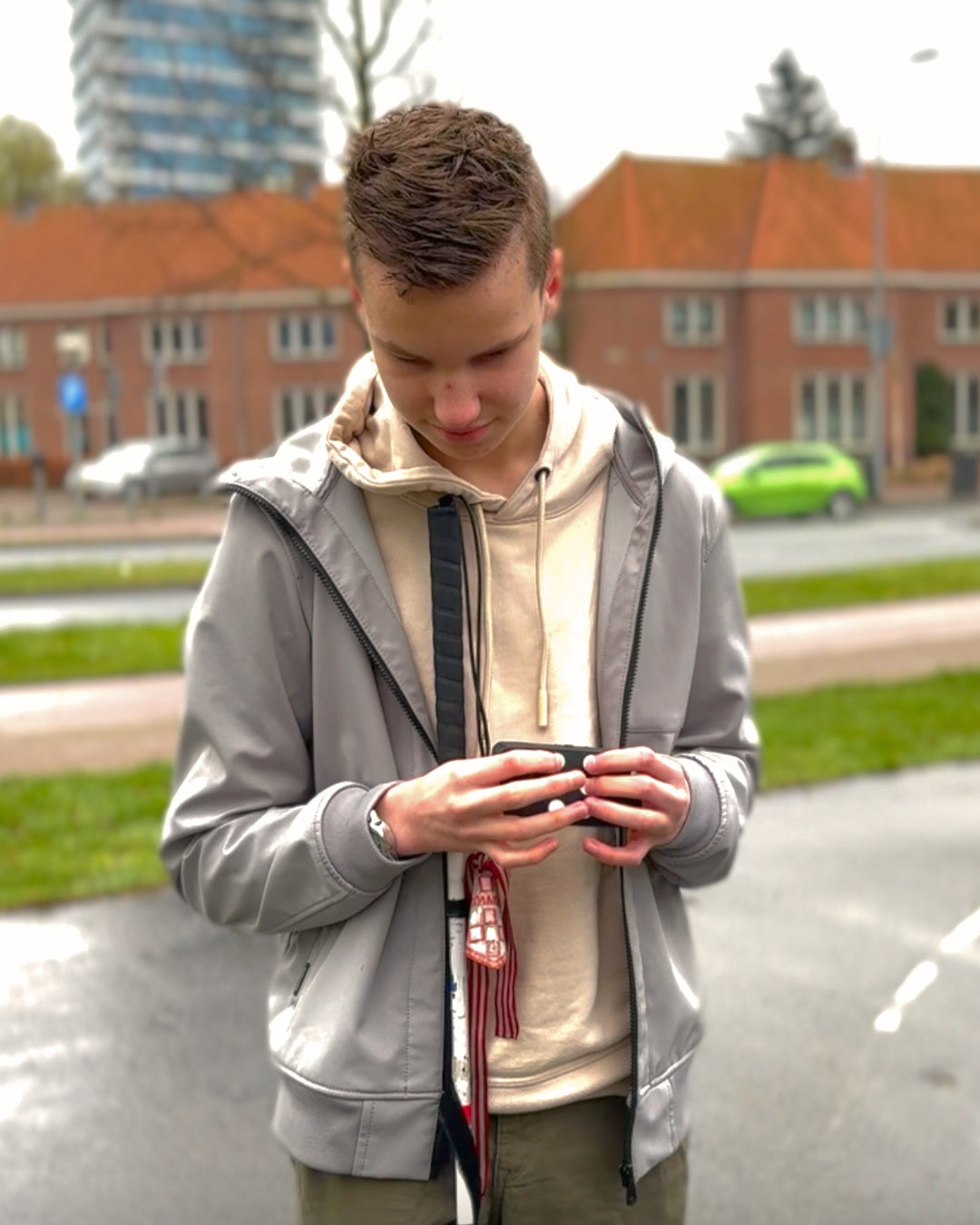 A young man using his Hable One standing in public