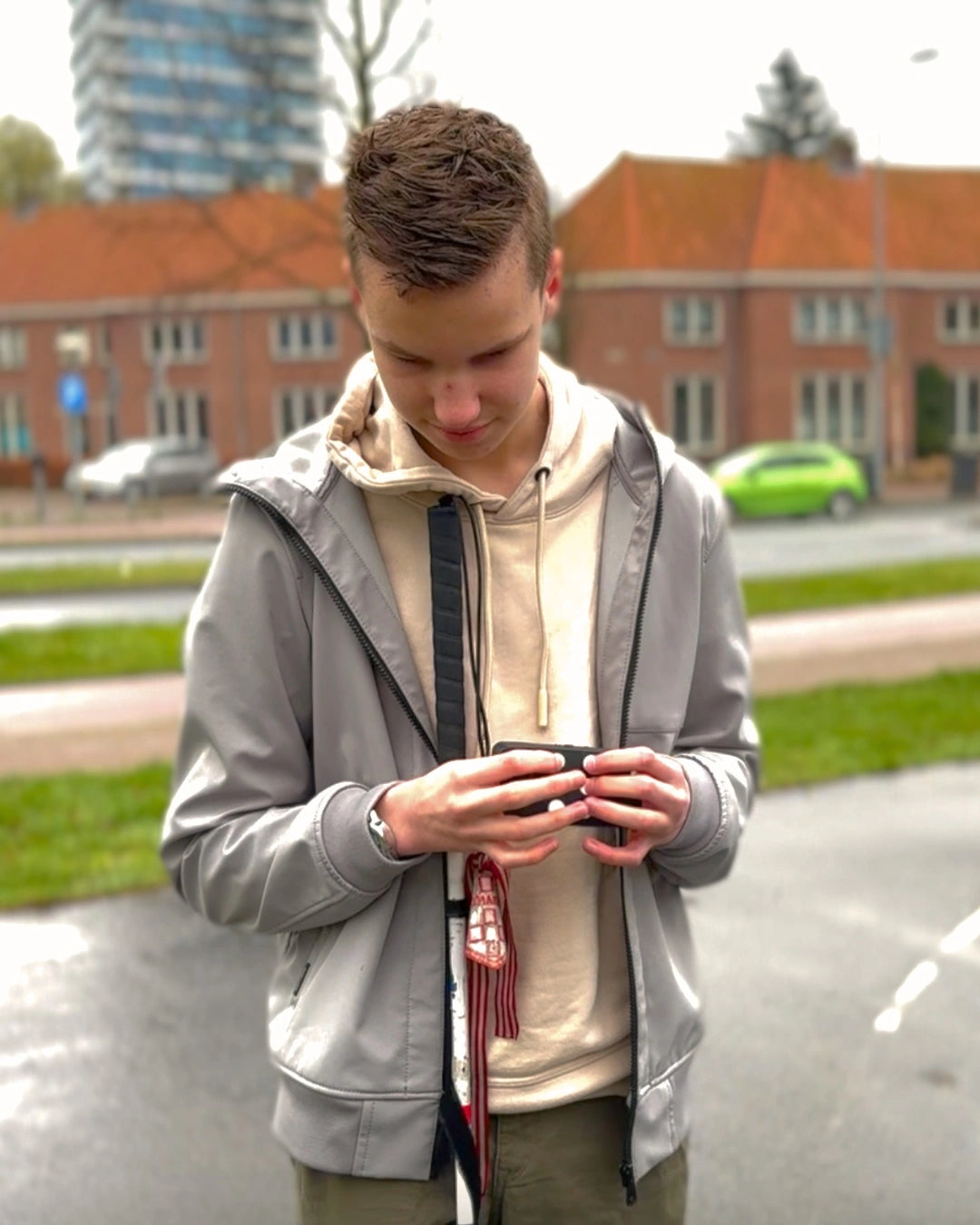 A young man using his Hable One standing in public.