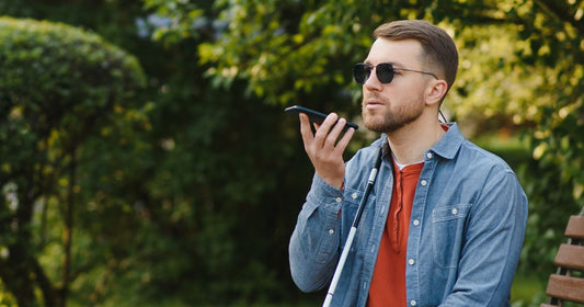 Visually impaired man talking on the phone in public