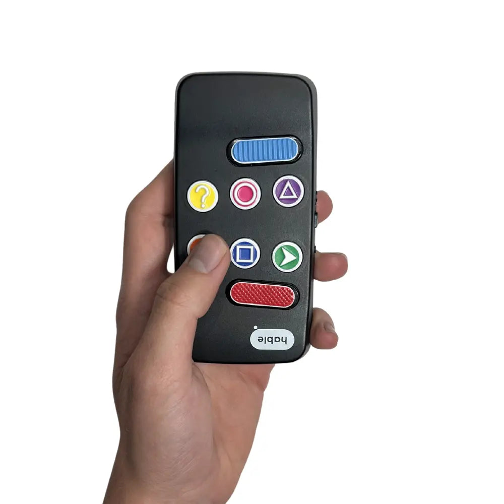 We now see a hand holding the Hable Easy. The device fits naturally in the hand and thumb presses the bottom left button on the device. "the swipe back button"