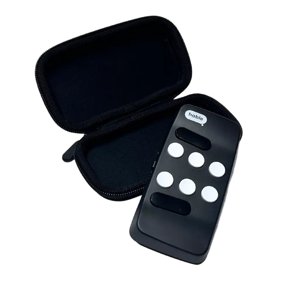 Open black hard-shell carry case shown next to a black Hable controller to demonstrate size and storage. Hable device is not included.