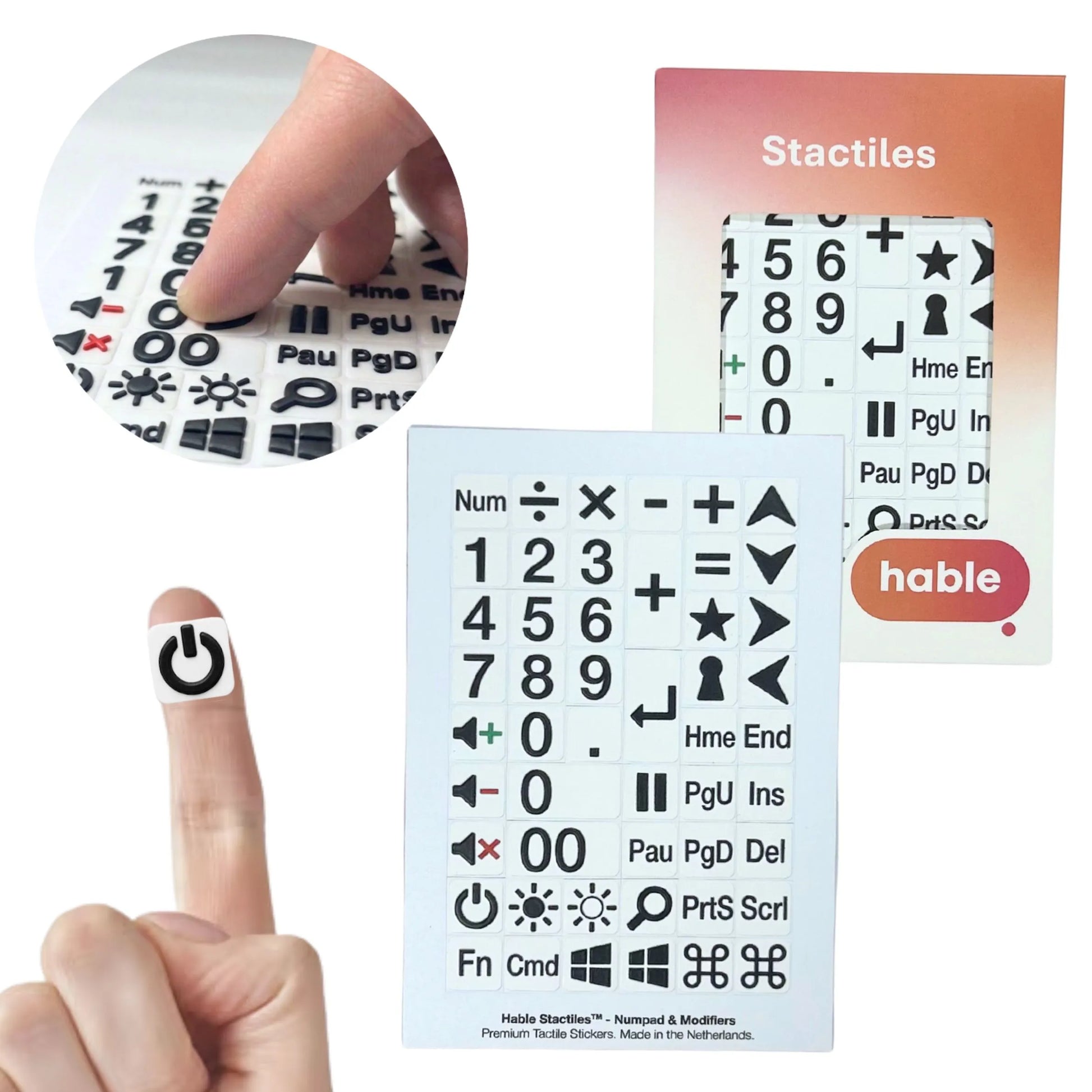 A composite image of the Hable Stactiles Numpad & Modifiers set. A circular inset shows fingers touching raised black-on-white keyboard stickers. A single power symbol sticker is shown on a fingertip for scale. The full sheet of 50 stickers includes a numeric keypad (0-9), mathematical operators, arrow keys, and modifiers like "Fn", "Cmd", Windows and Apple logos, and function keys such as "Del", "Hme", and "End". The retail box is visible on the right.