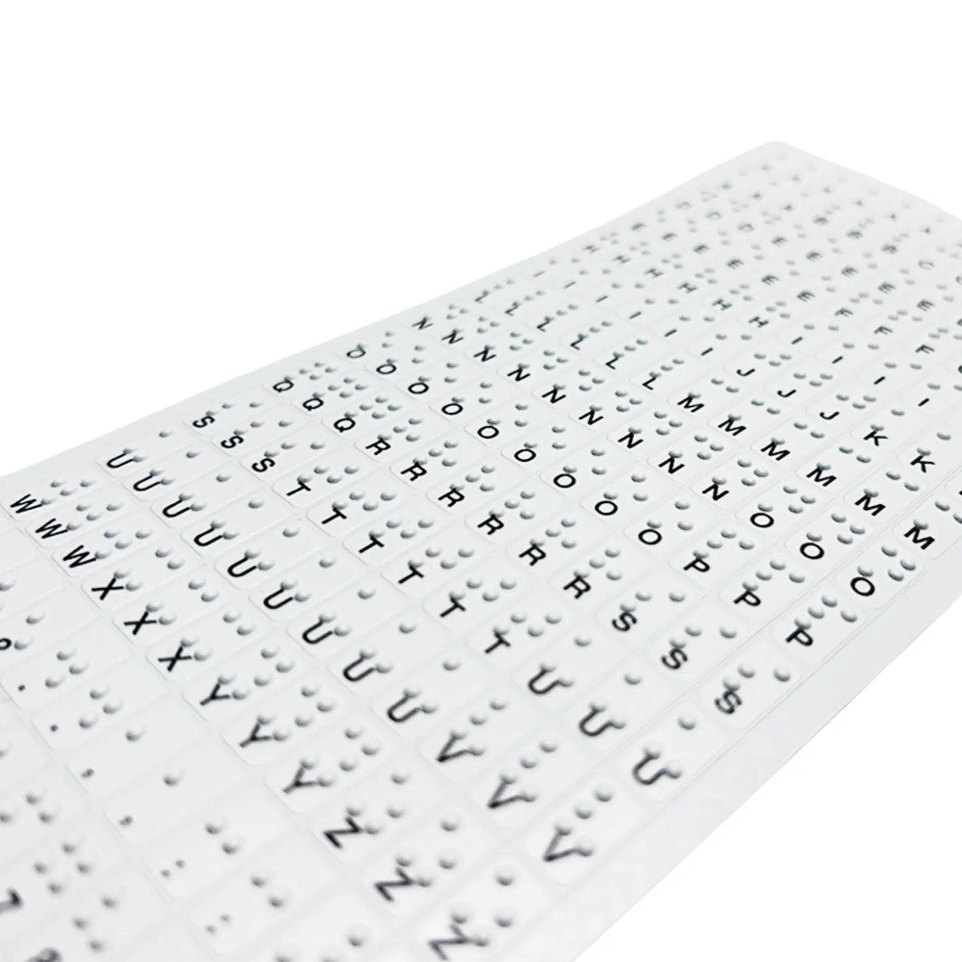 Close-up, angled perspective shot of Stactiles Braille stickers highlighting the high-quality, UV-embossed tactile dots. The image shows the crisp height of the Braille cells over the visual letters U through Z, demonstrating the durable and professional finish of the stickers.
