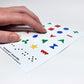 Close-up photo of an index finger feeling the raised appliance control symbols on the "Hable Stactiles - General Utility" sticker sheet.