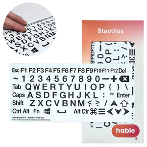 A composite image showcasing the Stactiles QWERTY Keyboard set. A circular inset in the top-left shows fingers touching the raised, high-contrast stickers. The main image features a full sheet of 76 tactile stickers covering every standard key, including Esc, F1–F12, numbers, the full QWERTY alphabet, and modifier keys like Shift, Enter, and Command. The Hable retail packaging is shown on the right.