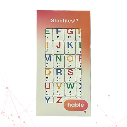 A packaged Stactiles Letters sheet showing raised, colorful alphabet stickers with braille dots. The packaging features a pink-to-orange gradient top section with “Stactiles™” and a window revealing the tactile letters, with the Hable logo at the bottom.