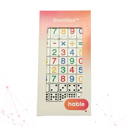 A loose Stactiles Numbers sheet featuring raised tactile stickers of numbers, math symbols, dice patterns, and currency symbols. The stickers are arranged in rows on a transparent backing with a faint red grid.